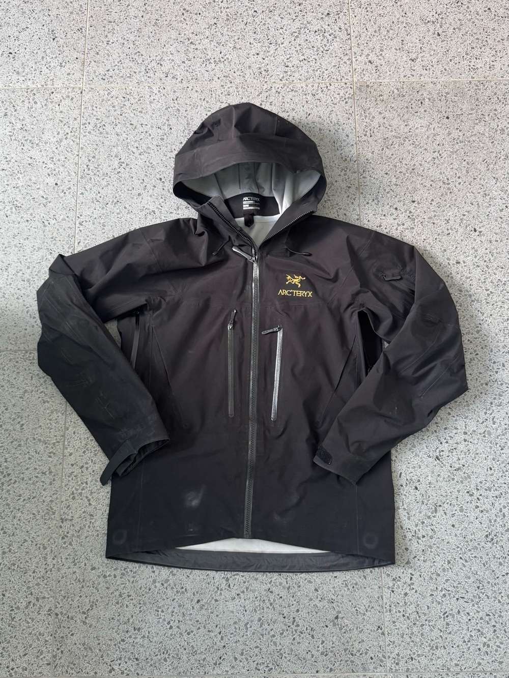Arc'teryx Alpha SV Men's Black Hooded Waterproof Shell with Gold Logo